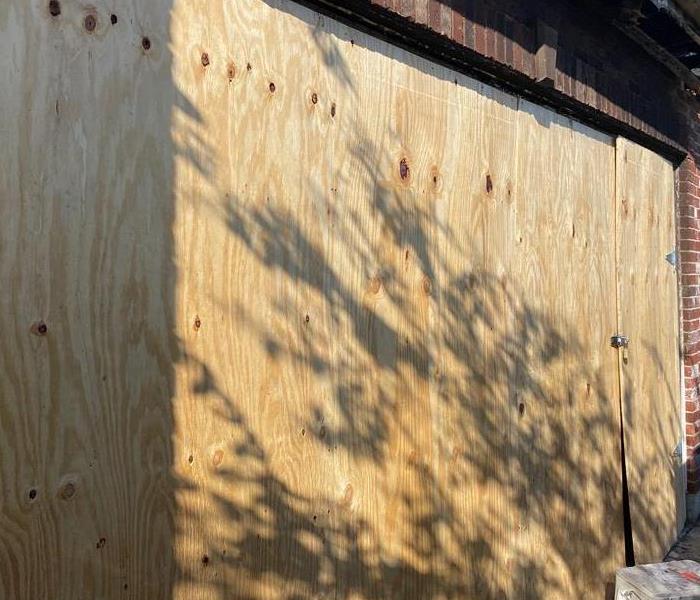 garage door opening boarded up by wood