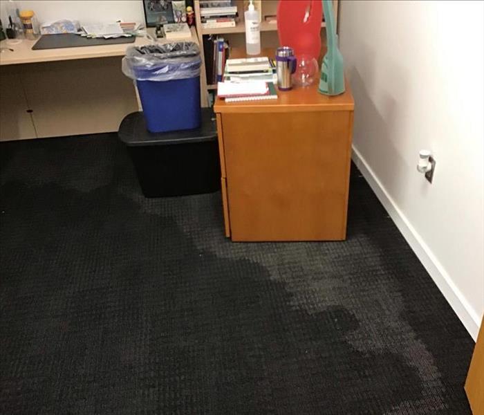 one office with visible water damage to the carpet
