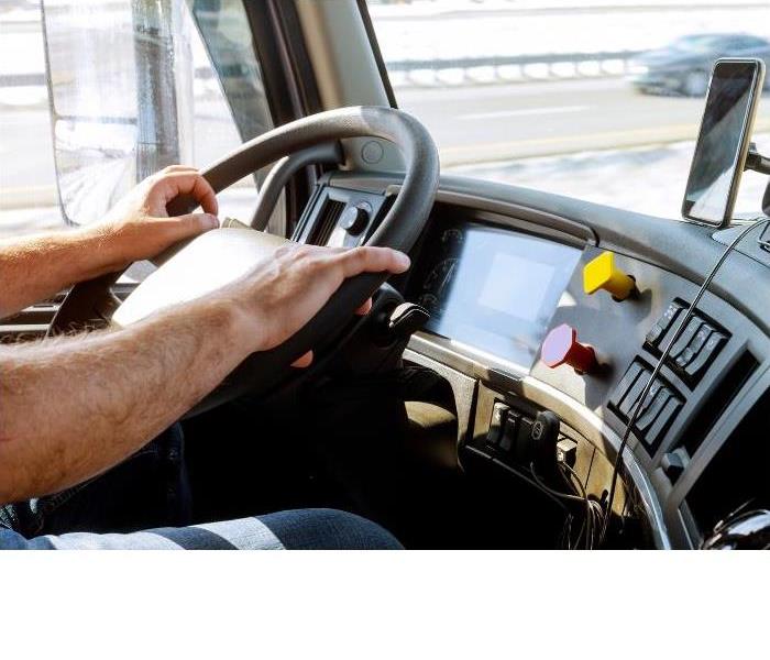man gripping steering wheel in truck