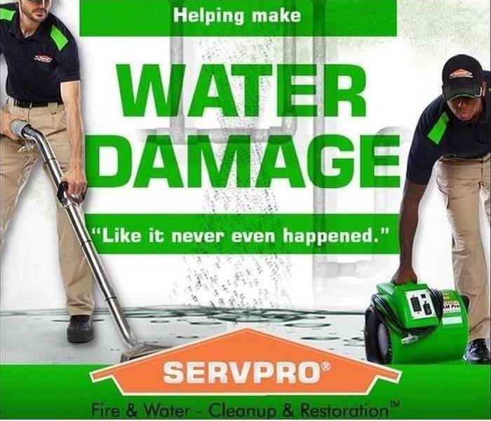 SERVPRO® techs cleaning up water damage along with SERVPRO® house logo